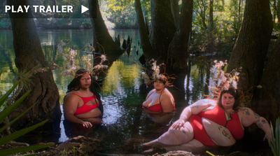 “How to Carry Water” directed by Sasha Wortzel. Three people dressed in red sit in water surrounded by trees. https://vimeo.com/866542171