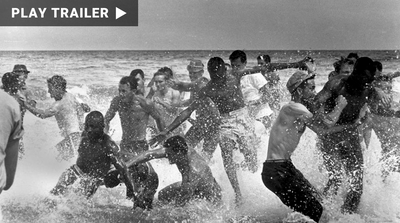 Trailer for documentary "Wade in the Water: Drowning in Racism" directed by Cathleen Dean. Black and white image of men splashing and running in ocean. https://vimeo.com/1045880677