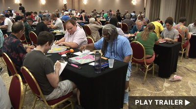 Trailer for documentary “WORD MASTER: ALFRED BUTTS AND THE STORY OF SCRABBLE” directed by Jerry Murphy. A host of people sitting in a room playing Scrabble. https://vimeo.com/997902615