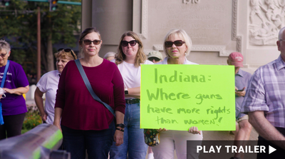 Trailer for documentary “Under G-d" directed by Paula Eiselt. A group of women, with one woman holding up a protest sign. https://vimeo.com/1001392981