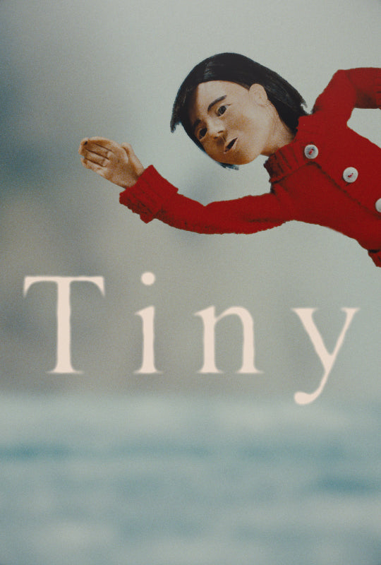 Film poster for "TINY". A doll waves, dressed in red.