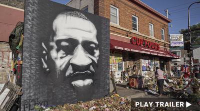 Trailer for documentary "Say His Name: Five Days For George Floyd" directed by Cy Dodson. Mural of George Floyd in black and white next to store. https://vimeo.com/703559553