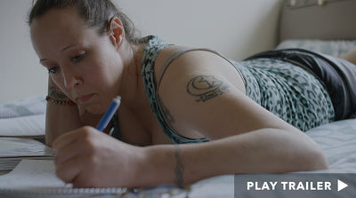 Trailer for documentary "Guest House" directed by Hannah Dweck & Yael Luttwak. Woman laying down on bed writing in journal. https://vimeo.com/385332361